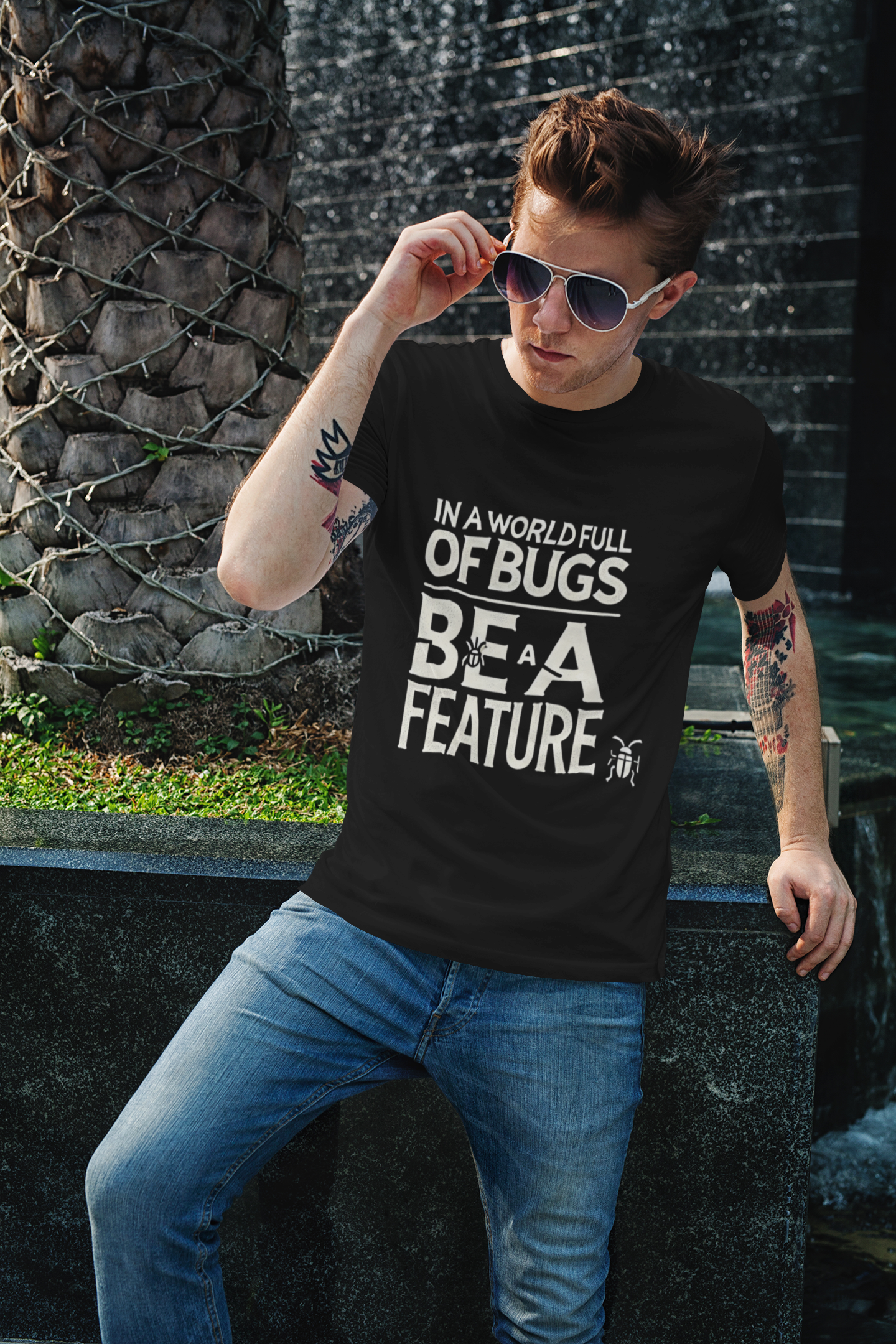 In a world full of bugs be a feature Unisex Softstyle T-Shirt